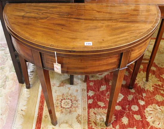 A George III mahogany and crossbanded demi lune folding card table, W.3ft